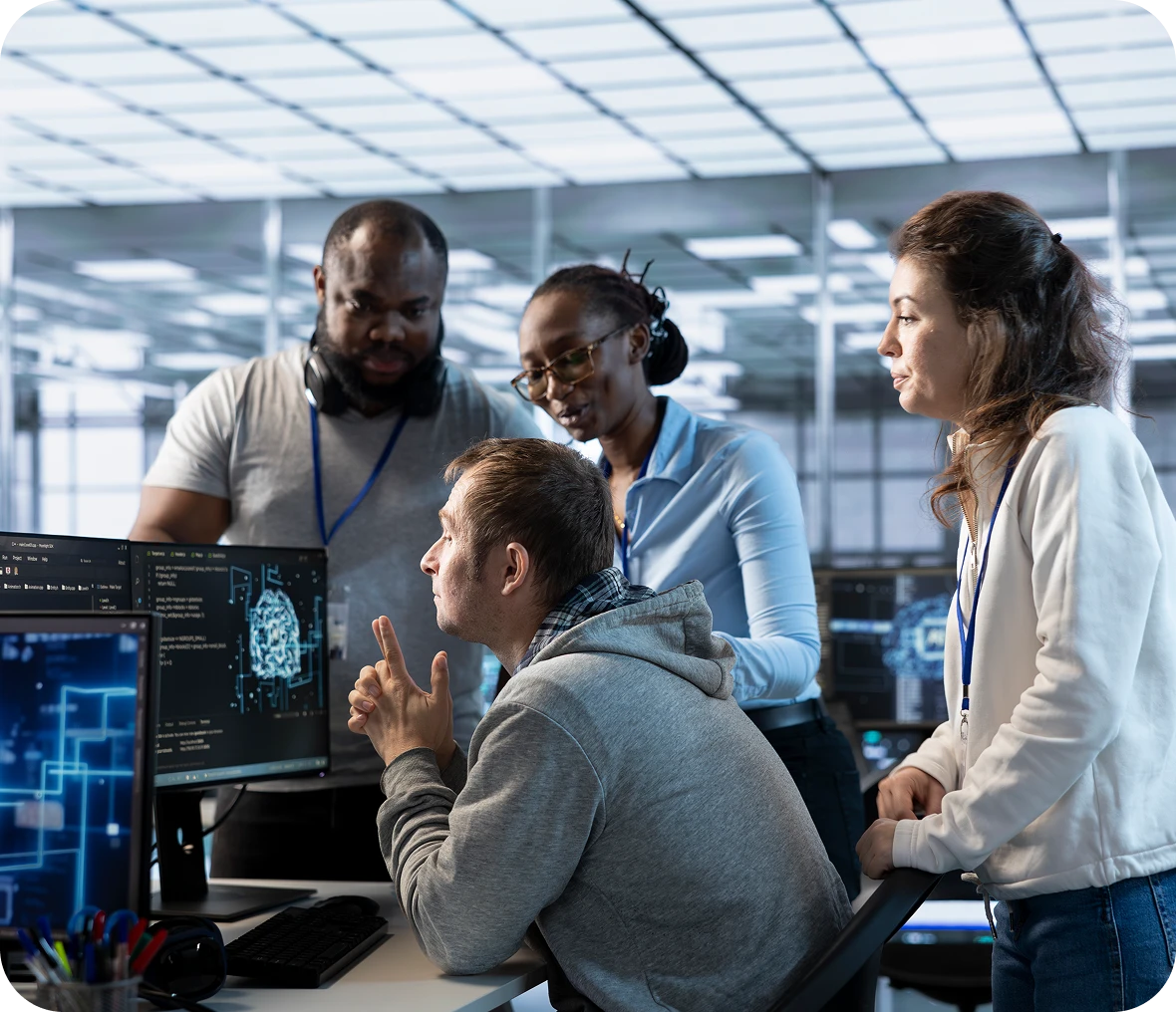 Team collaborating on computer screens in office.
