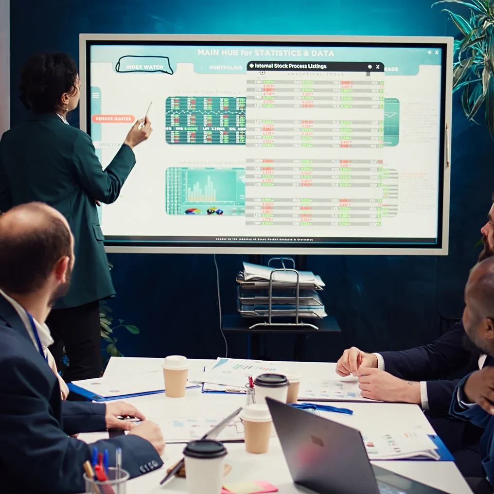 Business presentation with diverse team and screen.