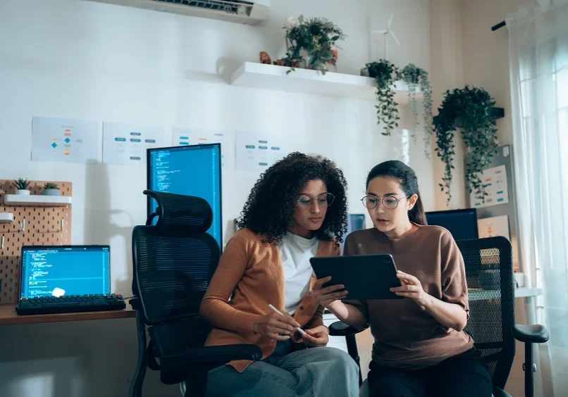 Two women collaborating in a modern office.